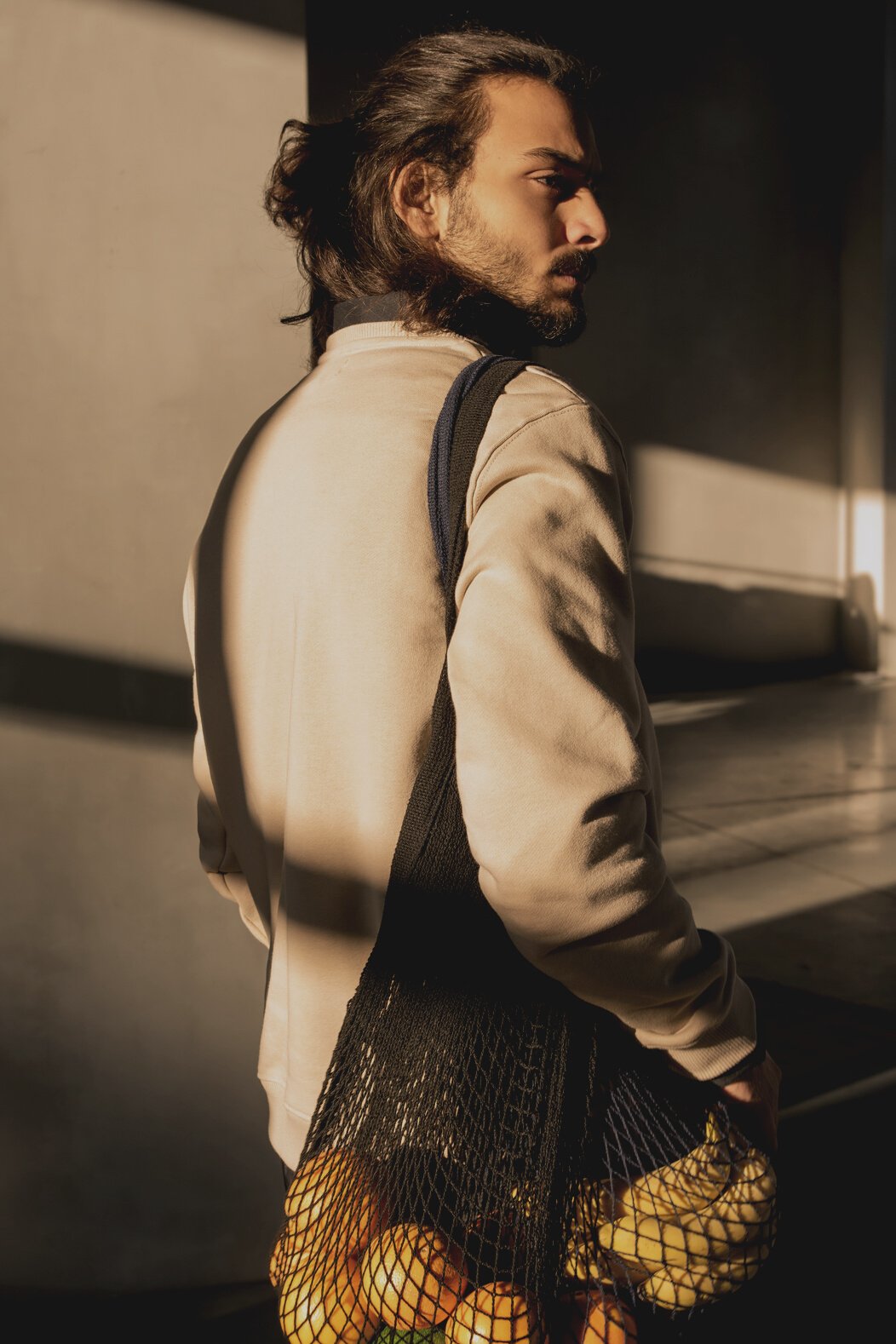 Man Carrying Bag of Fruits